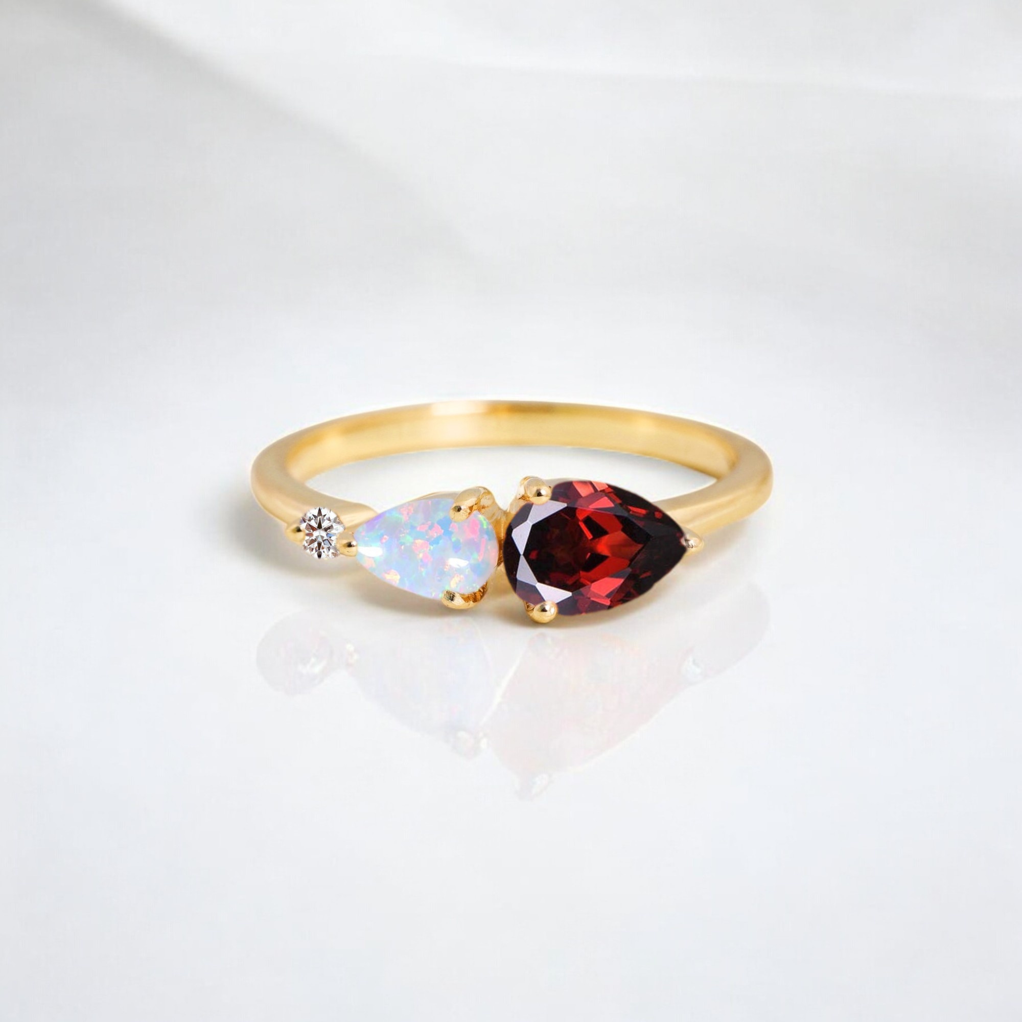 Garnet Promise Ring Opal Engagement Ring CZ Diamond Proposal Ring January Birthstone Statement Jewelry Happy Holiday Gift For Her This Garnet Promise Ring is a bold and captivating symbol of love and commitment. Featuring a stunning Garnet gemstone, the January Birthstone, the ring glows with rich red hues, symbolizing passion, energy, and devotion. The Opal accents add a touch of ethereal beauty, reflecting a soft iridescence, while the CZ Diamonds offer extra brilliance and sparkle, making this ring truly shine. Perfect as a Proposal Ring or Engagement Ring, this piece is a statement of both timeless elegance and modern style. Crafted with attention to detail, this ring exudes sophistication and is perfect for someone who appreciates unique statement jewelry. Whether as a Holiday Gift for Her or a meaningful Promise Ring, this piece is sure to impress with its bold colors and stunning design. Celebrate her special day with a ring that’s as unique and beautiful as she is.