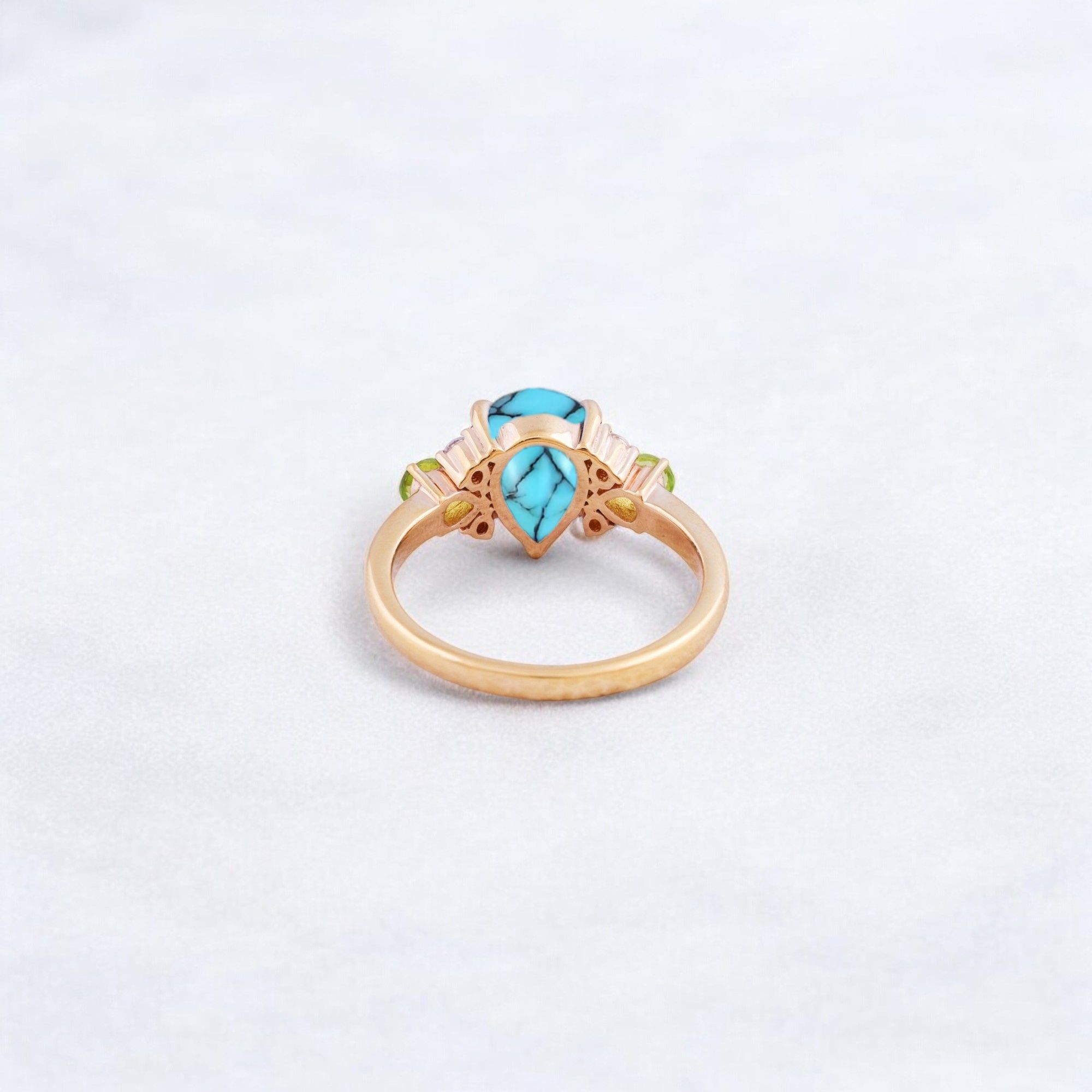 Pear Cut Turquoise Ring Art Deco Handmade Proposal Ring Peridot Alternative Cluster Women Jewelry CZ Diamond Gift Ring For Her Turquoise Ring for Women: A Symbol of Beauty, Protection & Love 💙✨ A turquoise ring is a timeless and meaningful piece of jewelry, known for its vibrant blue-green hues and rich cultural significance. Treasured for centuries, turquoise symbolizes protection, wisdom, and emotional balance, making it a perfect choice for women who appreciate both beauty and meaning in their jewelry. Why Choose a Turquoise Ring? ✅ Symbol of Love & Friendship – Turquoise has long been associated with strong relationships, loyalty, and positive energy. ✅ Protection & Healing – Believed to shield the wearer from negative energy and bring emotional stability. ✅ Unique & Eye-Catching – Each turquoise stone has a one-of-a-kind color and pattern, making every ring special. ✅ Alternative to Traditional Gemstones – A great choice for those who love bohemian, vintage, or artistic jewelry styles. Turquoise in Jewelry & Styling 💎 Accented with CZ Diamonds & Peridot – Enhances the brilliance and elegance of the ring. 💍 Perfect in Various Metal Settings – Looks stunning in gold, silver, and rose gold, complementing its striking blue tones. ✨ Art Deco & Handmade Designs – Adds a vintage and unique touch, making the ring stand out. Perfect for Special Occasions 🎁 Birthday & Holiday Gifts – A meaningful and stylish present for a loved one. 💍 Engagement & Promise Rings – A distinctive alternative to diamonds. 🎂 December Birthstone Jewelry – Ideal for those born in December. Would you like styling tips or care instructions for a turquoise ring? 😊💙