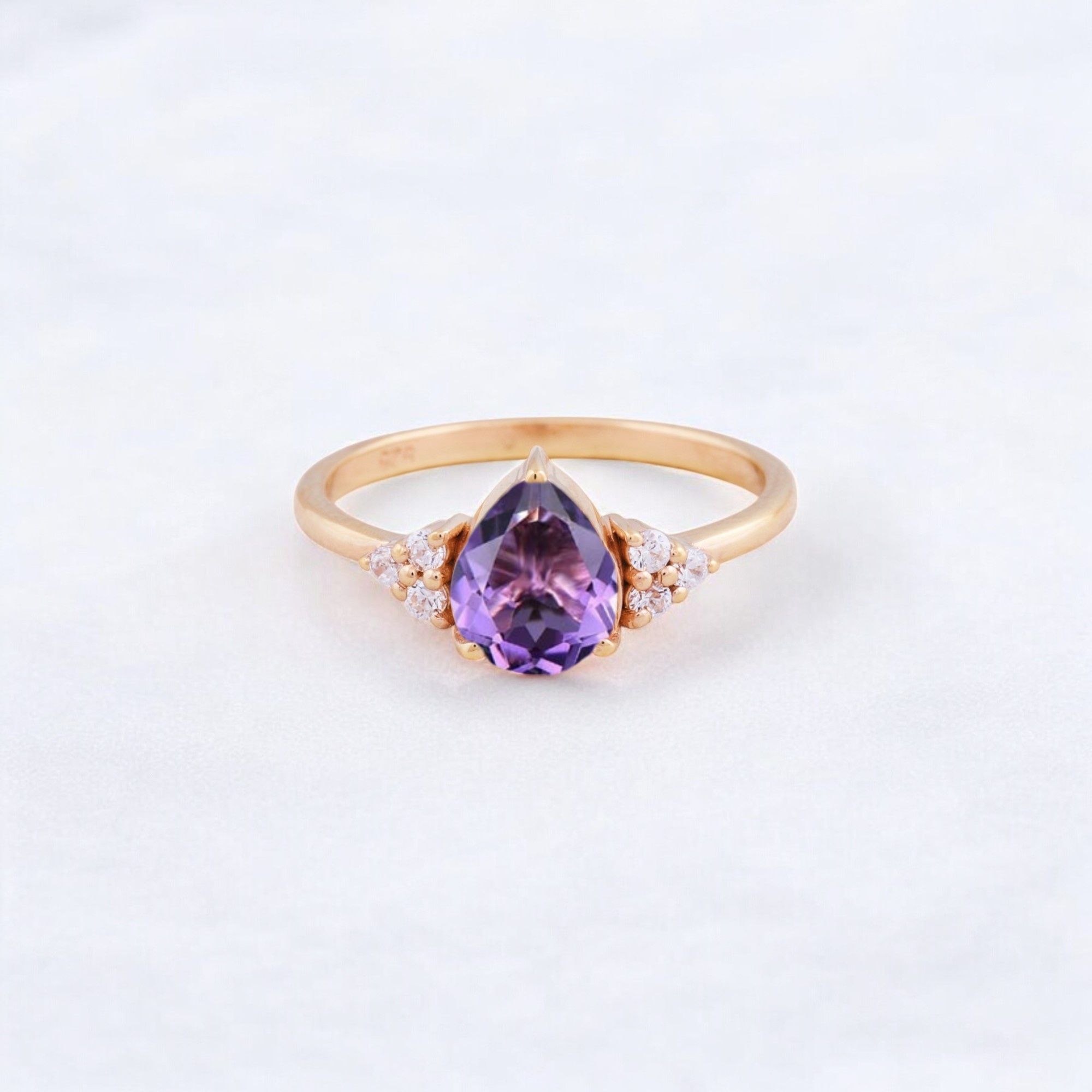 Purple Amethyst Engagement Ring February Birthstone Gemstone Ring Anniversary Birthday Gift For Her Yellow Gold CZ Diamond Ring Amethyst Stone: The Gem of Peace, Love & Wisdom 💜✨ Amethyst, the stunning February birthstone, is cherished for its deep purple hue and powerful symbolism. Known as the stone of tranquility and spiritual clarity, it has been revered for centuries for its ability to bring balance, protection, and inner strength. Benefits of Amethyst ✅ Symbol of Love & Devotion – Amethyst is associated with deep emotional connections, making it perfect for engagement or anniversary jewelry. ✅ Brings Calm & Balance – Helps reduce stress, anxiety, and negative energy while promoting inner peace. ✅ Enhances Spiritual Growth – Known for boosting intuition, creativity, and wisdom. ✅ Protective & Healing Properties – Believed to ward off negativity and promote overall well-being. Amethyst in Jewelry 💎 Looks Stunning in Various Cuts & Settings – Works beautifully in yellow gold, white gold, and rose gold. 💍 Often Accented with CZ Diamonds or Other Gemstones – Enhancing its brilliance and elegance. ✨ Versatile & Timeless – Perfect for engagement rings, promise rings, anniversary gifts, or everyday wear. Perfect for Special Occasions 🎂 February Birthstone Jewelry – An ideal gift for those born in February. 💍 Engagement & Promise Rings – A unique and meaningful alternative to traditional diamonds. 🎁 Anniversaries & Birthday Gifts – A thoughtful choice for someone special. Would you like tips on how to care for an amethyst ring or style it with other jewelry? 😊💜