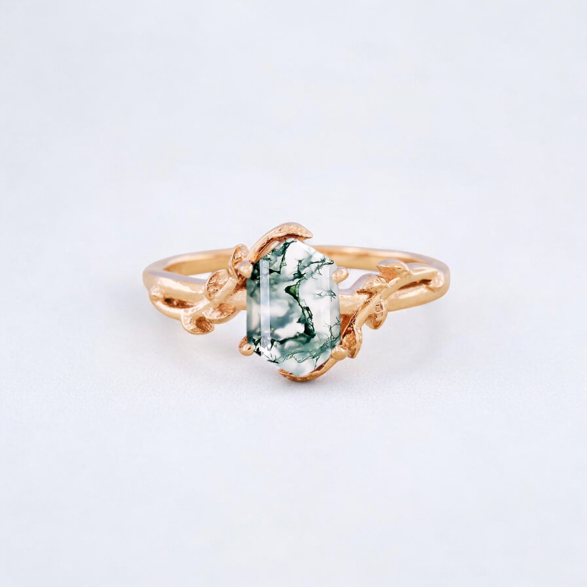 Natural Moss Agate Bridal Ring Nature Inspired Twig Ring Yellow Gold Personalized Jewelry Anniversary Gift For Mom Moss Agate is a beautiful and unique natural gemstone known for its captivating appearance, which often features patterns that resemble moss or foliage. It is a type of chalcedony, a mineral in the quartz family, and is typically semi-translucent with inclusions of green, brown, or black that form moss-like or plant-like patterns within the stone. Key Features of Moss Agate: 1. Appearance and Color: Moss-Like Inclusions: The defining characteristic of moss agate is its inclusions of green, brown, or sometimes black that mimic the appearance of moss, lichen, or even small plants. These patterns make each piece of moss agate unique, with no two stones being identical. Color Variations: Moss agate typically comes in shades of green, but it can also include hues of white, yellow, and even red or blue depending on the mineral content. Semi-Translucent: Moss agate has a translucent or semi-translucent appearance, giving it a serene, calming effect. 2. Origin and Rarity: Geological Formation: Moss agate is formed through volcanic activity and is generally found in riverbeds, lava deposits, and geodes. Sources: It can be found in various parts of the world, including India, Mexico, Brazil, and the United States (especially in Washington and Oregon). 3. Metaphysical Properties and Symbolism: Healing and Protection: Moss agate is often considered a stone of healing, believed to have strong earth energies that bring balance, stability, and a sense of grounding. It is said to help in physical healing and promote overall well-being. It is also thought to be a protective stone, especially when worn during times of transition or change, offering strength and resilience. Emotional Healing and Growth: Moss agate is often used to promote emotional growth and encourage feelings of self-love and self-acceptance. It can help in releasing emotional blockages, allowing the wearer to move forward with a clear heart and mind. The stone is said to attract abundance, prosperity, and new beginnings, making it a popular choice for those looking to start fresh or embark on new journeys in life. Connection to Nature: Moss agate is a nature-connected gemstone, believed to strengthen the bond with the earth. It is often associated with growth, fertility, and renewal, making it a wonderful stone for those who feel a deep connection to nature or work with plants, gardens, or agriculture.