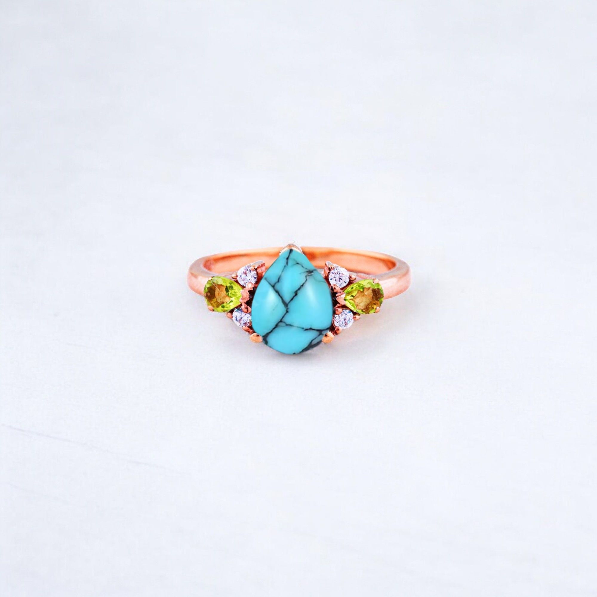 Pear Cut Turquoise Ring Art Deco Handmade Proposal Ring Peridot Alternative Cluster Women Jewelry CZ Diamond Gift Ring For Her Turquoise Ring for Women: A Symbol of Beauty, Protection & Love 💙✨ A turquoise ring is a timeless and meaningful piece of jewelry, known for its vibrant blue-green hues and rich cultural significance. Treasured for centuries, turquoise symbolizes protection, wisdom, and emotional balance, making it a perfect choice for women who appreciate both beauty and meaning in their jewelry. Why Choose a Turquoise Ring? ✅ Symbol of Love & Friendship – Turquoise has long been associated with strong relationships, loyalty, and positive energy. ✅ Protection & Healing – Believed to shield the wearer from negative energy and bring emotional stability. ✅ Unique & Eye-Catching – Each turquoise stone has a one-of-a-kind color and pattern, making every ring special. ✅ Alternative to Traditional Gemstones – A great choice for those who love bohemian, vintage, or artistic jewelry styles. Turquoise in Jewelry & Styling 💎 Accented with CZ Diamonds & Peridot – Enhances the brilliance and elegance of the ring. 💍 Perfect in Various Metal Settings – Looks stunning in gold, silver, and rose gold, complementing its striking blue tones. ✨ Art Deco & Handmade Designs – Adds a vintage and unique touch, making the ring stand out. Perfect for Special Occasions 🎁 Birthday & Holiday Gifts – A meaningful and stylish present for a loved one. 💍 Engagement & Promise Rings – A distinctive alternative to diamonds. 🎂 December Birthstone Jewelry – Ideal for those born in December. Would you like styling tips or care instructions for a turquoise ring? 😊💙
