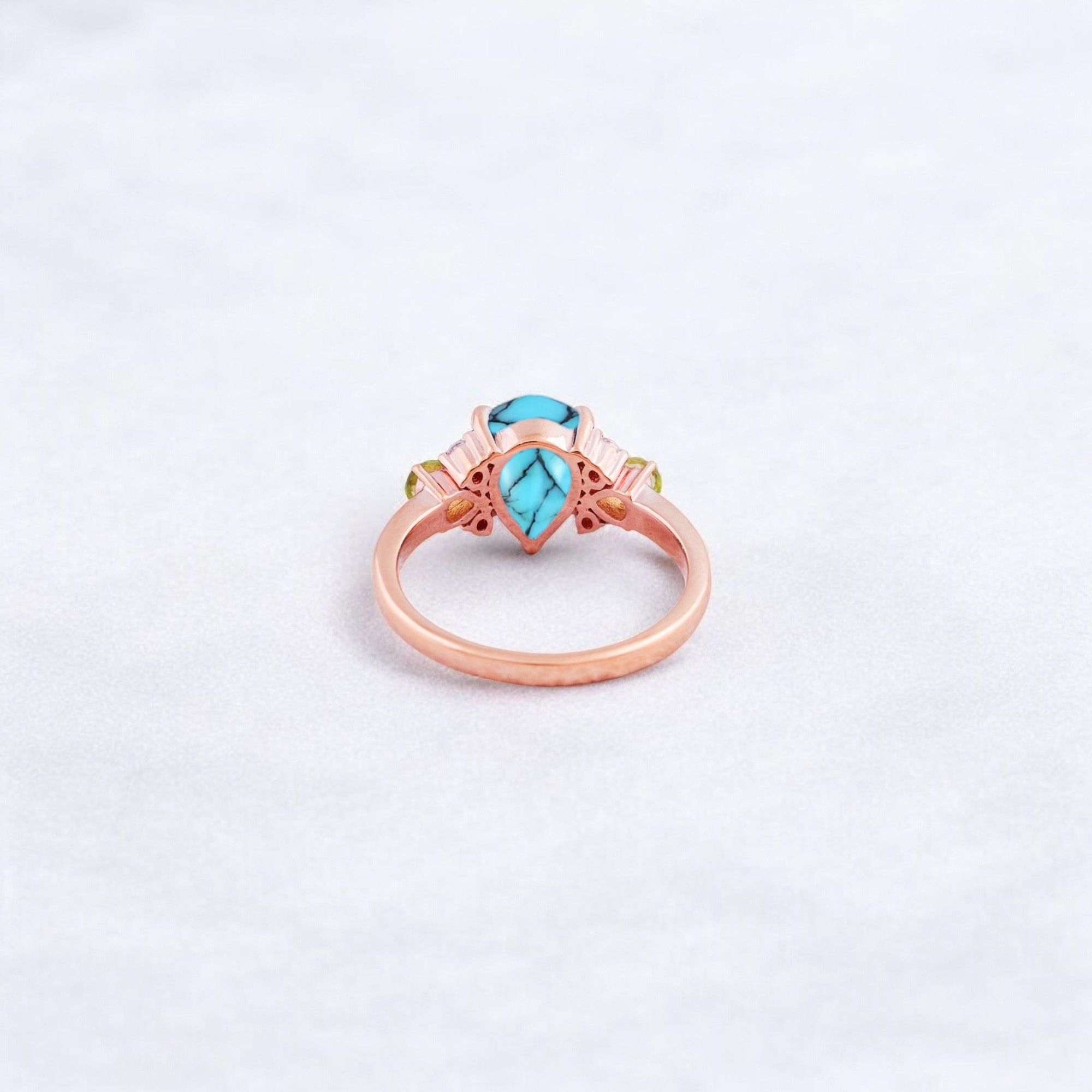 Pear Cut Turquoise Ring Art Deco Handmade Proposal Ring Peridot Alternative Cluster Women Jewelry CZ Diamond Gift Ring For Her Turquoise Ring for Women: A Symbol of Beauty, Protection & Love 💙✨ A turquoise ring is a timeless and meaningful piece of jewelry, known for its vibrant blue-green hues and rich cultural significance. Treasured for centuries, turquoise symbolizes protection, wisdom, and emotional balance, making it a perfect choice for women who appreciate both beauty and meaning in their jewelry. Why Choose a Turquoise Ring? ✅ Symbol of Love & Friendship – Turquoise has long been associated with strong relationships, loyalty, and positive energy. ✅ Protection & Healing – Believed to shield the wearer from negative energy and bring emotional stability. ✅ Unique & Eye-Catching – Each turquoise stone has a one-of-a-kind color and pattern, making every ring special. ✅ Alternative to Traditional Gemstones – A great choice for those who love bohemian, vintage, or artistic jewelry styles. Turquoise in Jewelry & Styling 💎 Accented with CZ Diamonds & Peridot – Enhances the brilliance and elegance of the ring. 💍 Perfect in Various Metal Settings – Looks stunning in gold, silver, and rose gold, complementing its striking blue tones. ✨ Art Deco & Handmade Designs – Adds a vintage and unique touch, making the ring stand out. Perfect for Special Occasions 🎁 Birthday & Holiday Gifts – A meaningful and stylish present for a loved one. 💍 Engagement & Promise Rings – A distinctive alternative to diamonds. 🎂 December Birthstone Jewelry – Ideal for those born in December. Would you like styling tips or care instructions for a turquoise ring? 😊💙