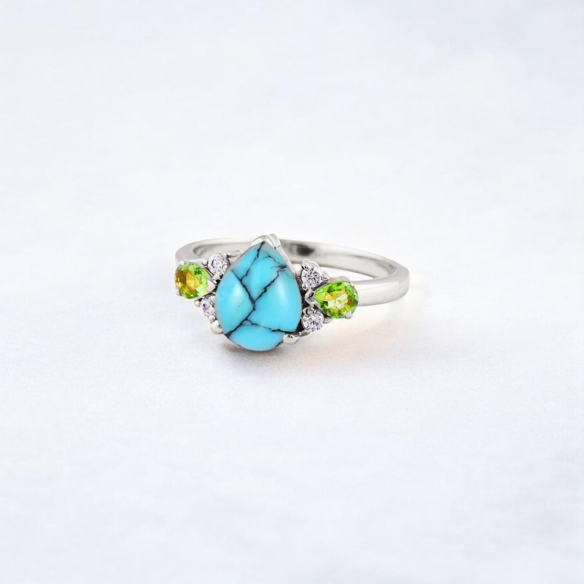 Pear Cut Turquoise Ring Art Deco Handmade Proposal Ring Peridot Alternative Cluster Women Jewelry CZ Diamond Gift Ring For Her Turquoise Ring for Women: A Symbol of Beauty, Protection & Love 💙✨ A turquoise ring is a timeless and meaningful piece of jewelry, known for its vibrant blue-green hues and rich cultural significance. Treasured for centuries, turquoise symbolizes protection, wisdom, and emotional balance, making it a perfect choice for women who appreciate both beauty and meaning in their jewelry. Why Choose a Turquoise Ring? ✅ Symbol of Love & Friendship – Turquoise has long been associated with strong relationships, loyalty, and positive energy. ✅ Protection & Healing – Believed to shield the wearer from negative energy and bring emotional stability. ✅ Unique & Eye-Catching – Each turquoise stone has a one-of-a-kind color and pattern, making every ring special. ✅ Alternative to Traditional Gemstones – A great choice for those who love bohemian, vintage, or artistic jewelry styles. Turquoise in Jewelry & Styling 💎 Accented with CZ Diamonds & Peridot – Enhances the brilliance and elegance of the ring. 💍 Perfect in Various Metal Settings – Looks stunning in gold, silver, and rose gold, complementing its striking blue tones. ✨ Art Deco & Handmade Designs – Adds a vintage and unique touch, making the ring stand out. Perfect for Special Occasions 🎁 Birthday & Holiday Gifts – A meaningful and stylish present for a loved one. 💍 Engagement & Promise Rings – A distinctive alternative to diamonds. 🎂 December Birthstone Jewelry – Ideal for those born in December. Would you like styling tips or care instructions for a turquoise ring? 😊💙