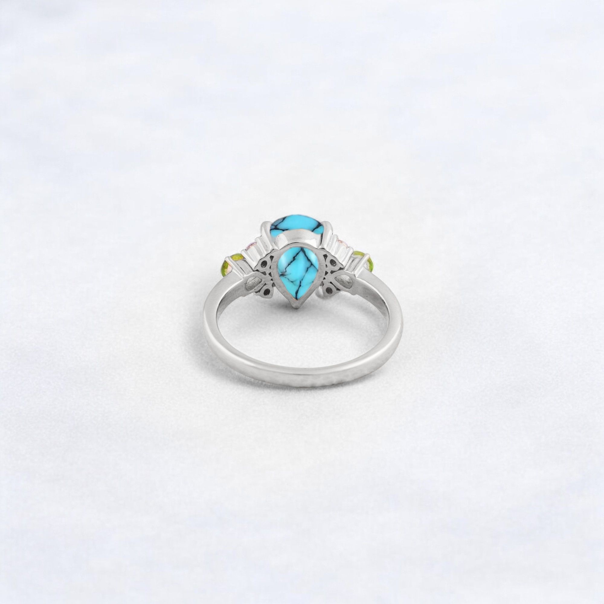 Pear Cut Turquoise Ring Art Deco Handmade Proposal Ring Peridot Alternative Cluster Women Jewelry CZ Diamond Gift Ring For Her Turquoise Ring for Women: A Symbol of Beauty, Protection & Love 💙✨ A turquoise ring is a timeless and meaningful piece of jewelry, known for its vibrant blue-green hues and rich cultural significance. Treasured for centuries, turquoise symbolizes protection, wisdom, and emotional balance, making it a perfect choice for women who appreciate both beauty and meaning in their jewelry. Why Choose a Turquoise Ring? ✅ Symbol of Love & Friendship – Turquoise has long been associated with strong relationships, loyalty, and positive energy. ✅ Protection & Healing – Believed to shield the wearer from negative energy and bring emotional stability. ✅ Unique & Eye-Catching – Each turquoise stone has a one-of-a-kind color and pattern, making every ring special. ✅ Alternative to Traditional Gemstones – A great choice for those who love bohemian, vintage, or artistic jewelry styles. Turquoise in Jewelry & Styling 💎 Accented with CZ Diamonds & Peridot – Enhances the brilliance and elegance of the ring. 💍 Perfect in Various Metal Settings – Looks stunning in gold, silver, and rose gold, complementing its striking blue tones. ✨ Art Deco & Handmade Designs – Adds a vintage and unique touch, making the ring stand out. Perfect for Special Occasions 🎁 Birthday & Holiday Gifts – A meaningful and stylish present for a loved one. 💍 Engagement & Promise Rings – A distinctive alternative to diamonds. 🎂 December Birthstone Jewelry – Ideal for those born in December. Would you like styling tips or care instructions for a turquoise ring? 😊💙
