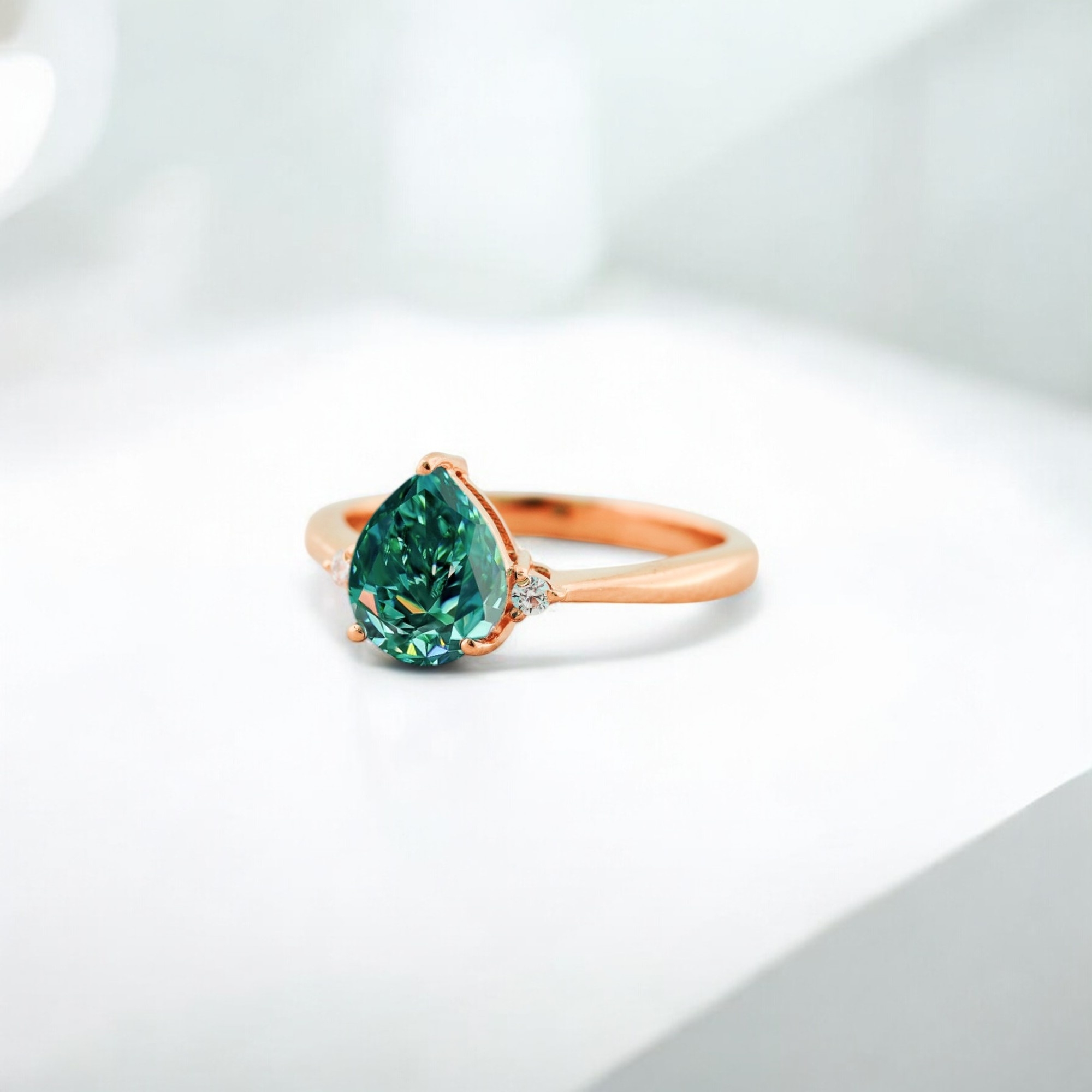 Pear Blue Green Moissanite Engagement Ring Wedding Ring Cyan Blue Moissanite Ring Prong Vintage Ring for Women CZ Diamond Anniversary Gift Ring Green Moissanite is a captivating gemstone that combines both beauty and brilliance. Known for its exceptional sparkle, it is a popular alternative to traditional diamonds, offering a unique and vibrant color that stands out. Here’s more about the green moissanite stone: 1. Brilliance and Sparkle: Moissanite is famous for its incredible brilliance, which is even higher than diamonds. Its refractive index (a measure of how much light is bent as it passes through the stone) makes it one of the most sparkling gemstones, making green moissanite particularly eye-catching. 2. Color Range: Green moissanite features a vivid green hue, which can range from a light mint or seafoam green to a deeper emerald tone. The intensity of the green color can vary, but it always retains the stone's signature brilliance. 3. Affordable Luxury: While green moissanite offers a luxurious appearance, it is considerably more affordable than diamonds, making it an excellent choice for those who want a stunning gemstone without the hefty price tag. Moissanite offers the same sparkle as a diamond at a fraction of the cost, making it an ideal option for engagement rings, wedding bands, and other fine jewelry. 4. Durability: Green moissanite is an incredibly durable stone, ranking 9.25 on the Mohs scale of hardness (diamonds rank 10). This makes it suitable for daily wear, and it’s resistant to scratches, ensuring it maintains its beauty over time. 5. Ethical and Sustainable: One of the major benefits of moissanite is that it is lab-grown, making it an ethical and environmentally friendly alternative to mined gemstones. Choosing a green moissanite stone is a responsible choice for consumers who are concerned about the environmental and ethical impact of traditional gemstone mining.